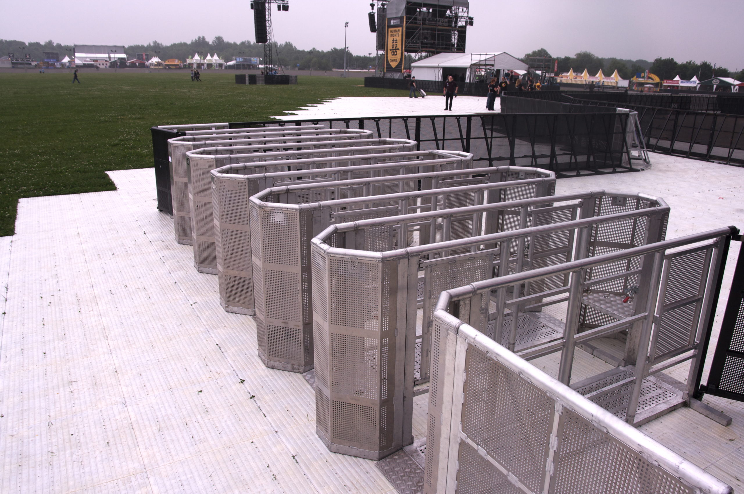 Crowd control entry gates managing orderly event access at a festival checkpoint, ensuring security and efficient crowd flow.